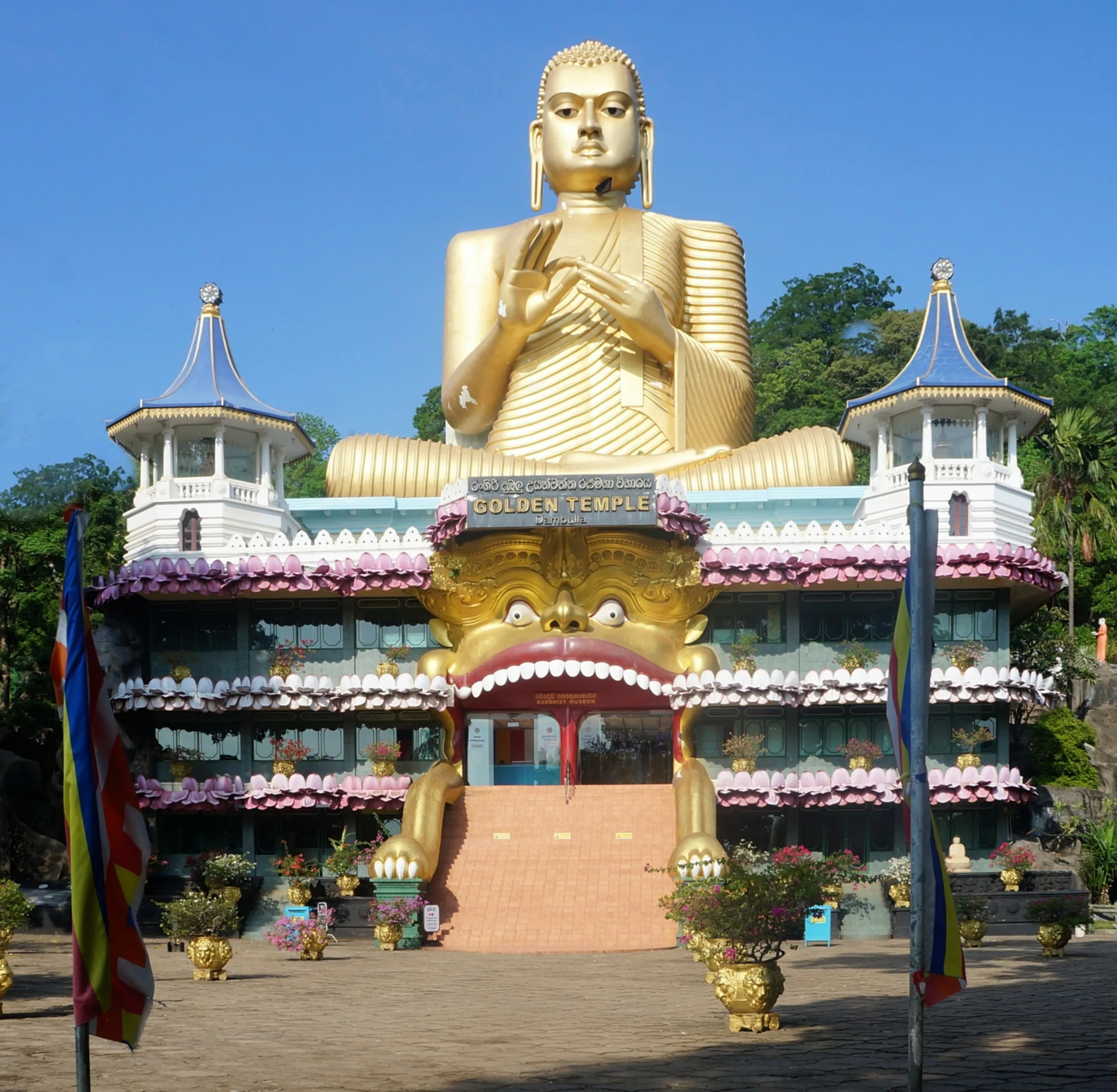 Golden Buddha statue at the entrance to the Dambulla Cave Temple complex, Sri Lanka