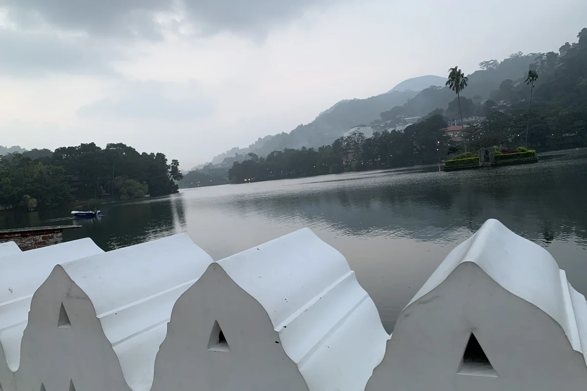 Kandy Lake at dawn with mist over the surrounding hills, Sri Lanka
