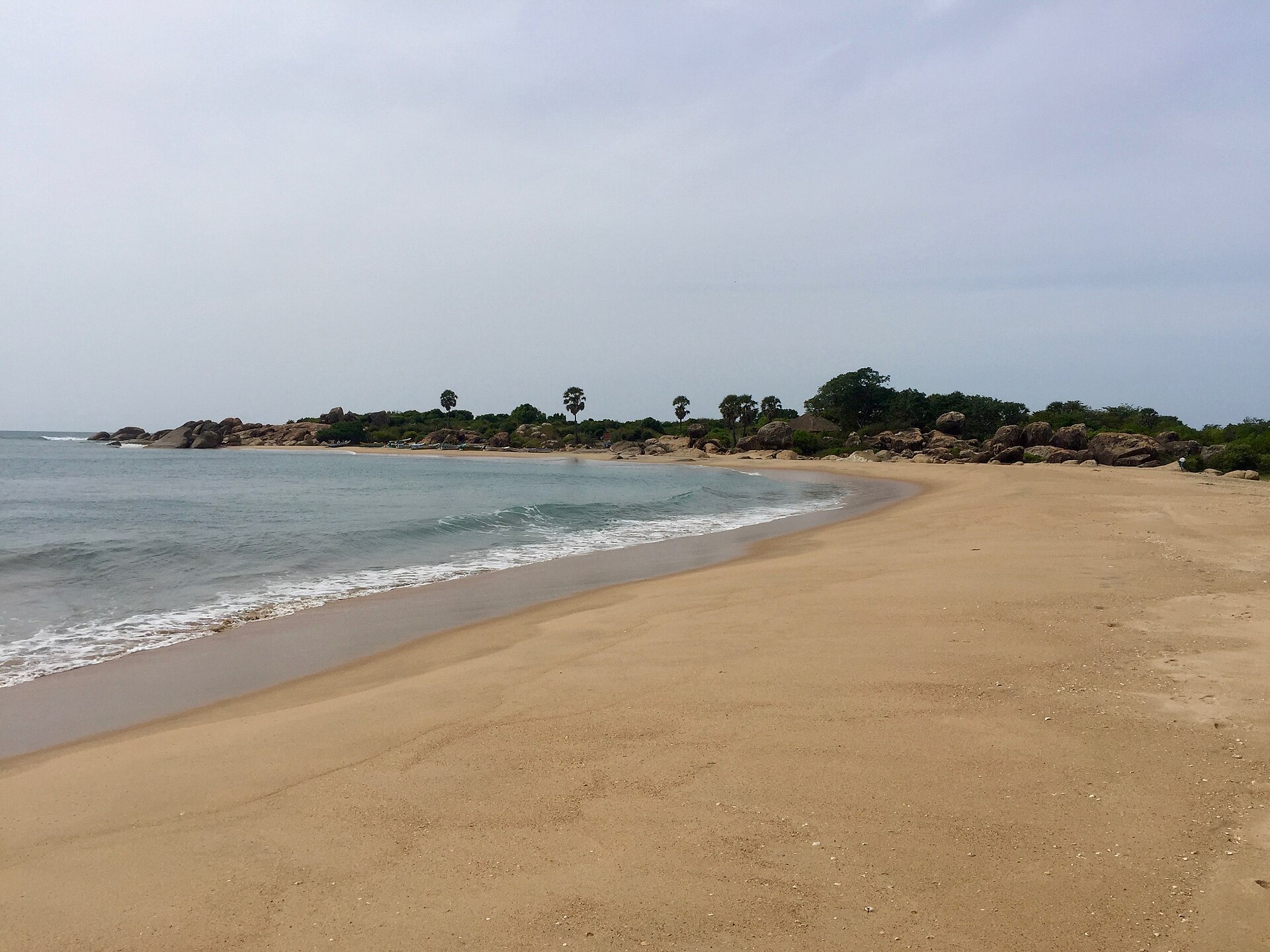 Surfers riding waves at Whiskey Point, Arugam Bay, Sri Lanka