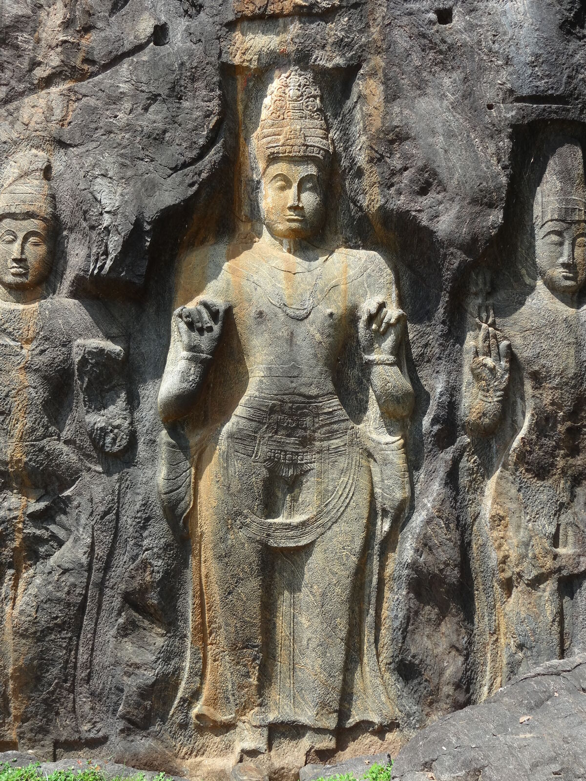 The colossal standing Buddha carved into the granite cliff at Buduruwagala Raja Maha Viharaya near Wellawaya, Sri Lanka