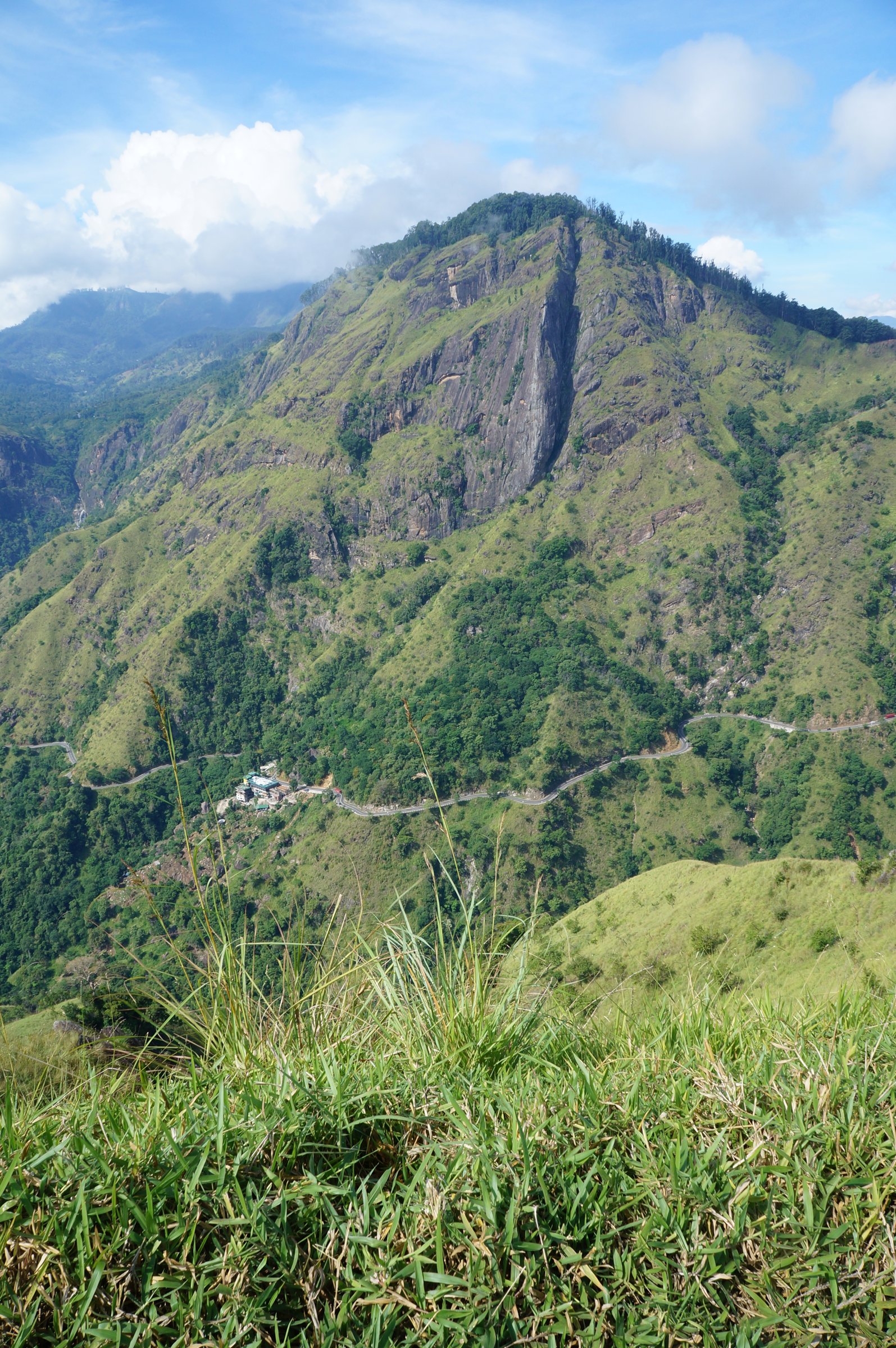 Little Adam's Peak in Ella, Sri Lanka, with green hills and misty sky