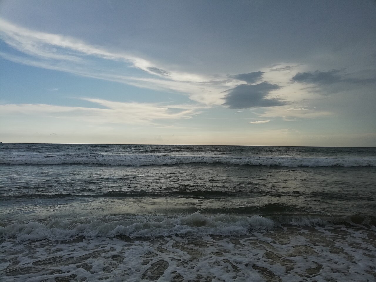The long sandy crescent of Mount Lavinia beach south of Colombo, with the Indian Ocean and the railway line running along the shore