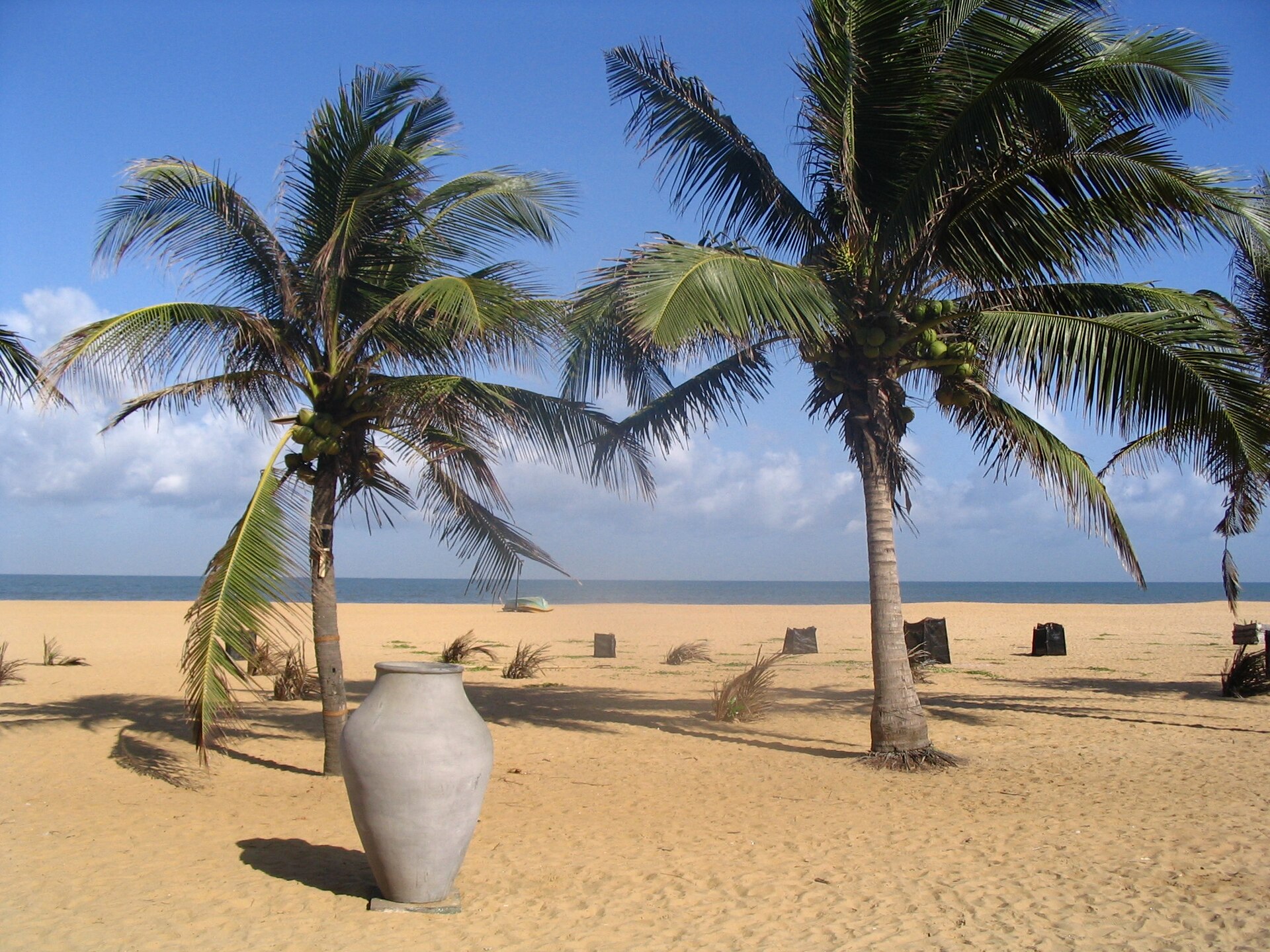 Negombo beach in Sri Lanka in the late afternoon with fishing boats offshore