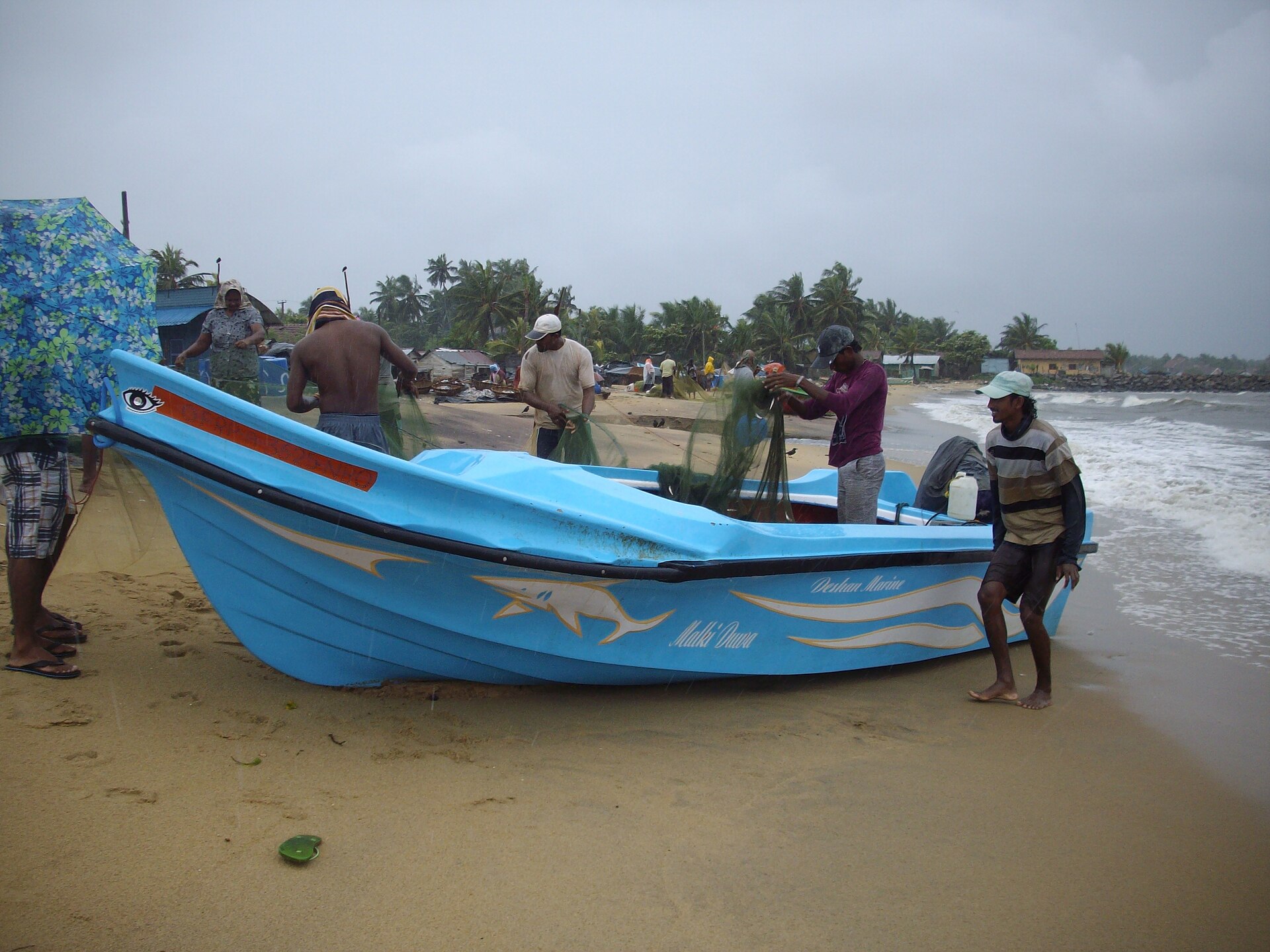 Colourful fishing boats drawn up on Negombo Beach, the traditional end point of a Sri Lanka itinerary