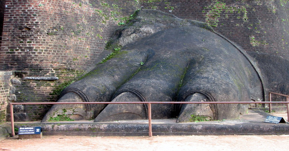 Sigiriya Rock Fortress rising from lush green forest in the Cultural Triangle