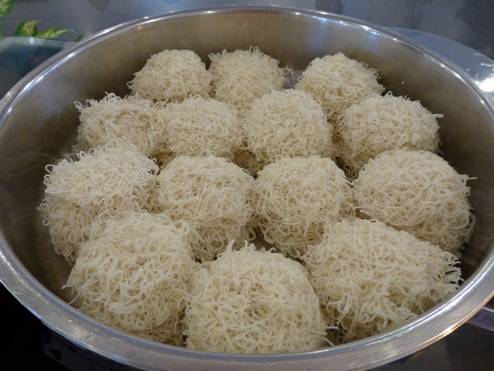 String hoppers served with a spread of vegetable curries and coconut sambol in Sri Lanka — a classic vegan-friendly breakfast